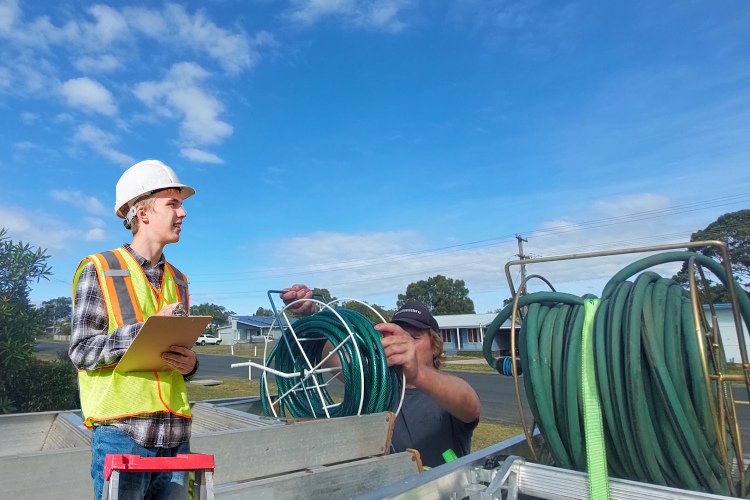 Gutter cleaner in ulladulla loads hoses following thorough gutter rinsing.